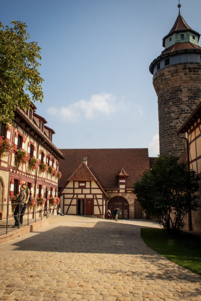 castle tower with red and white timberframed buildings with cobblestone paths while in nuremberg for two days