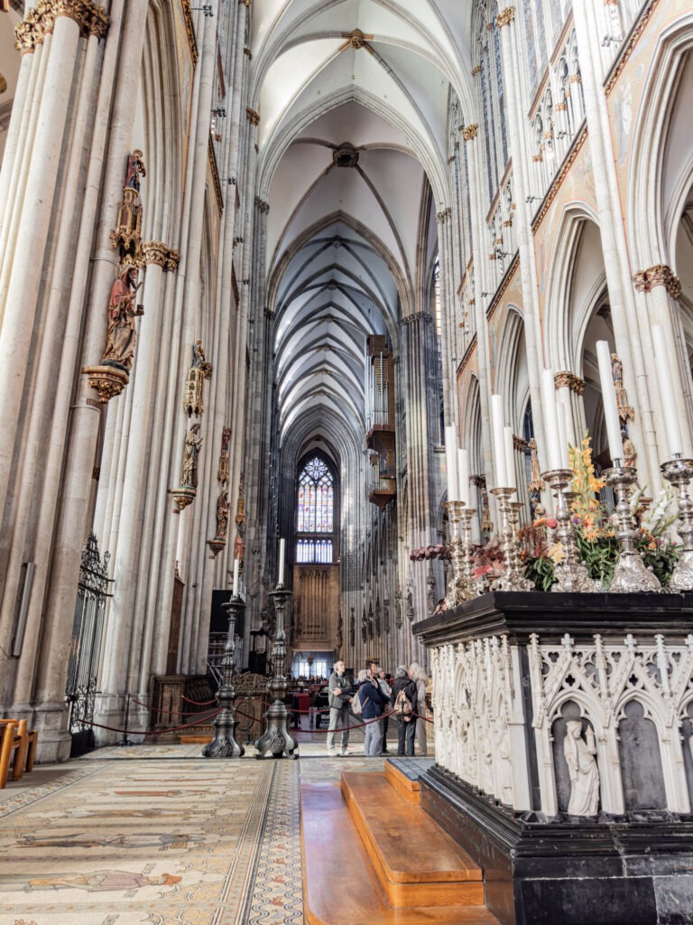 interior of cologne cathedral with soaring ceilings, at the alter
