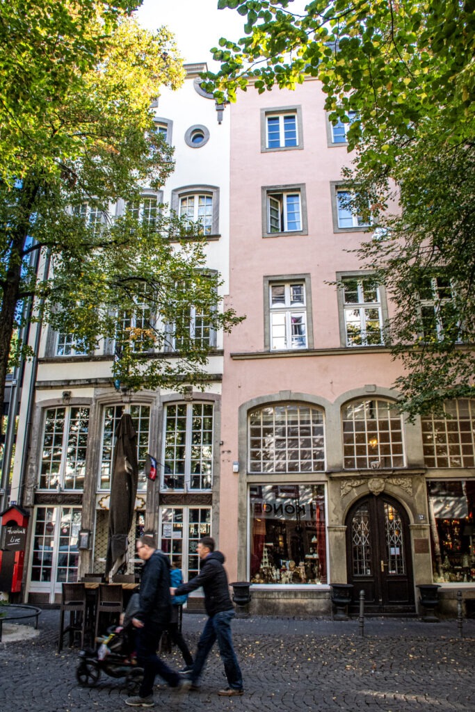 family walking with stroller in streets of cologne germany