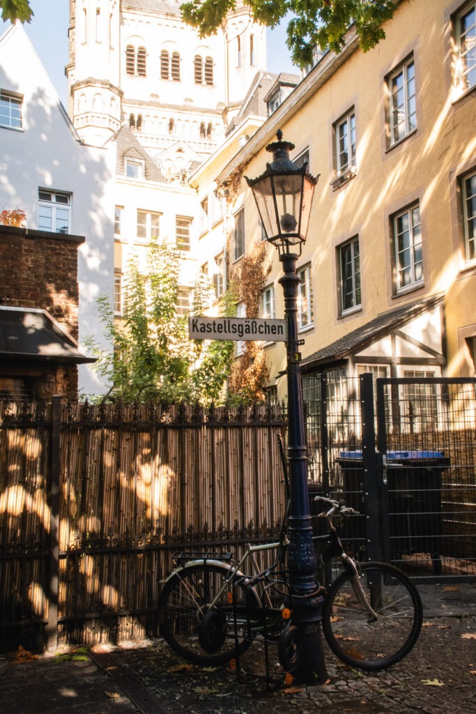 quiet square with bike leaning on lamp post in cologne germany