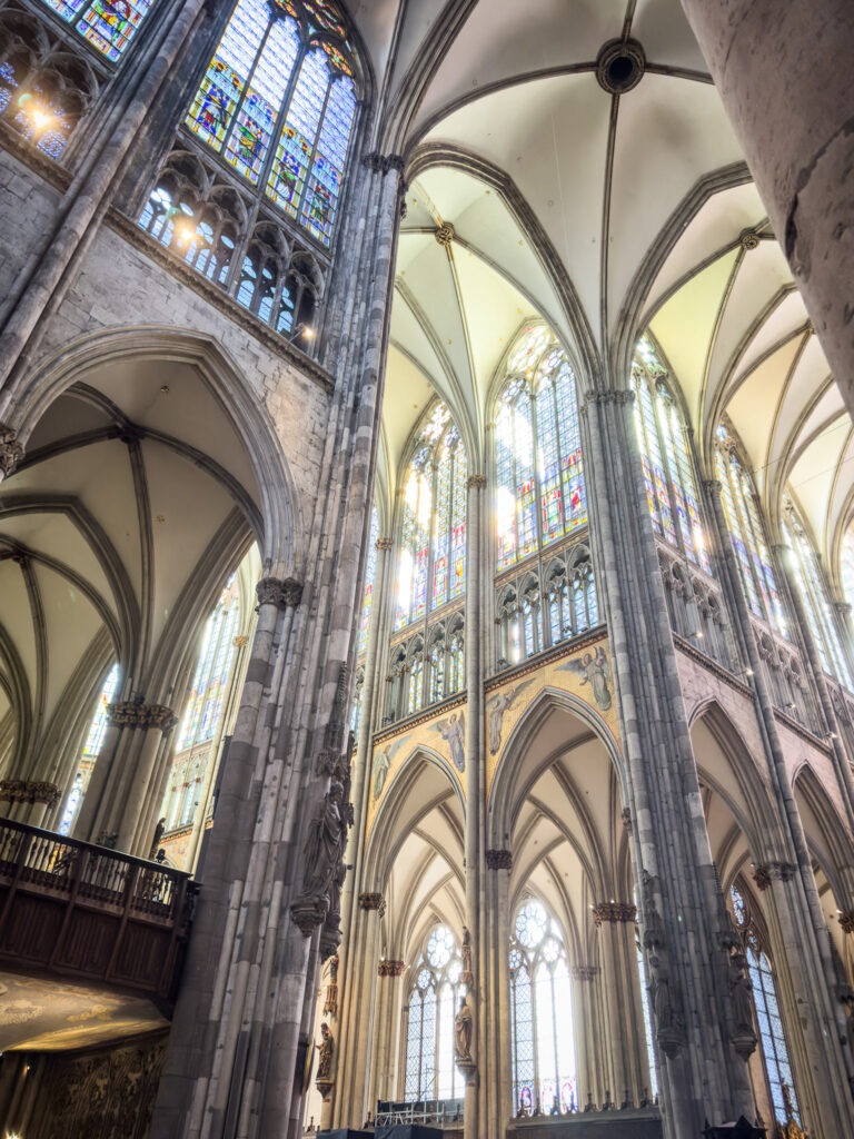 inside the cathedral in cologne with soaring ceilings and stained glass
