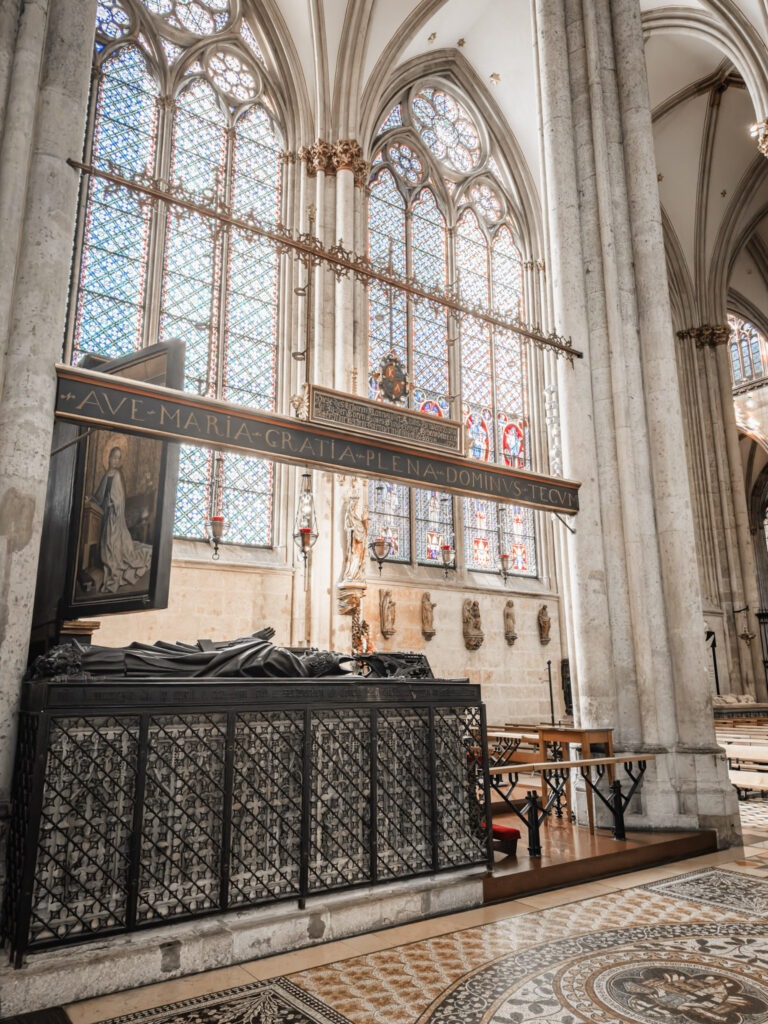 inside the cologne cathedral that shows the shrine with stained glass archways