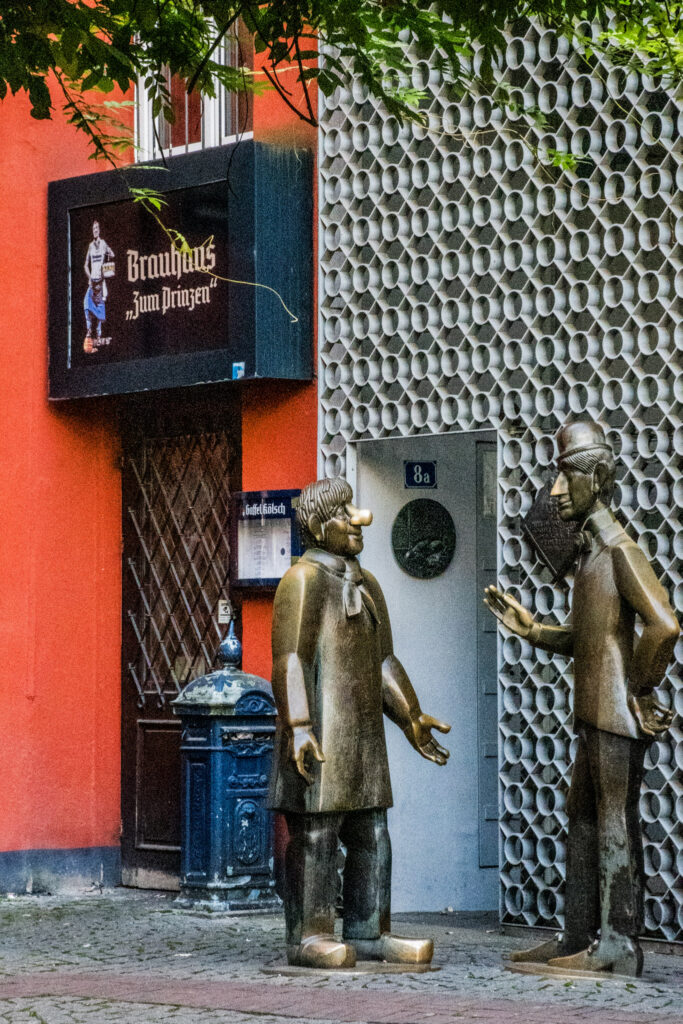 What to See + Do in Cologne in One Day 4 while spending 1 day in Cologne, stumbled upon these bronze statues that represent the folklore of the city