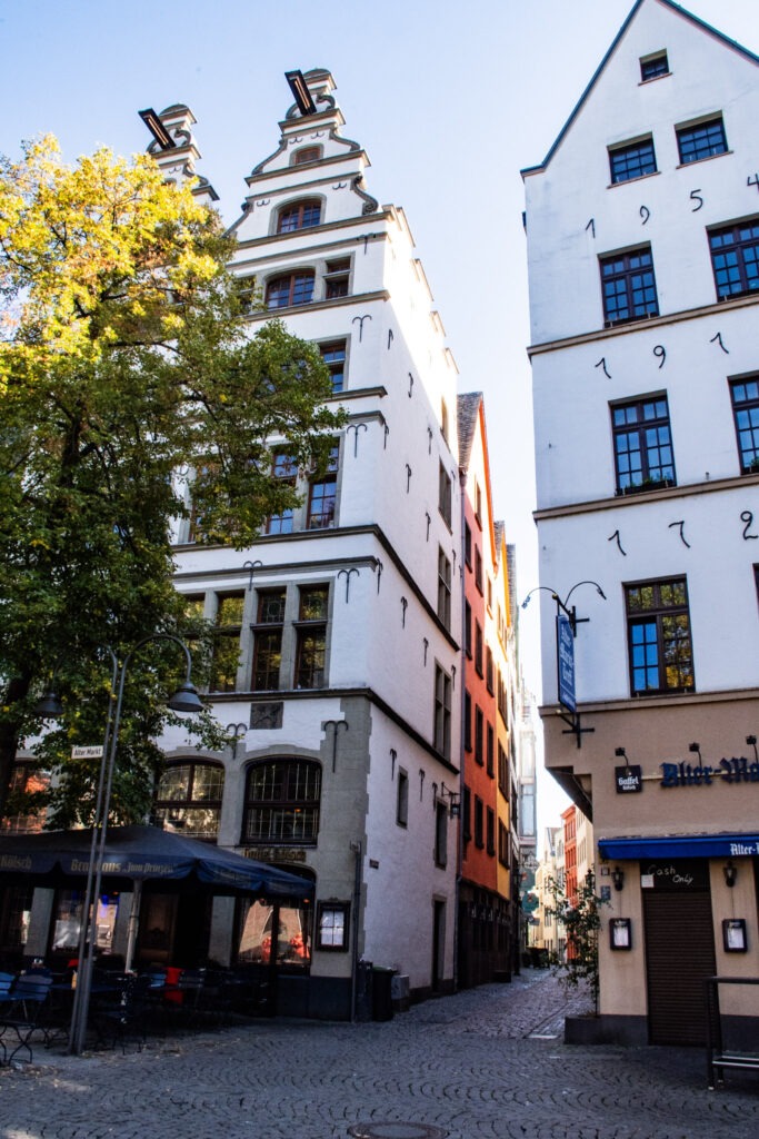 tall white buildings on market square in Cologne's Old Town