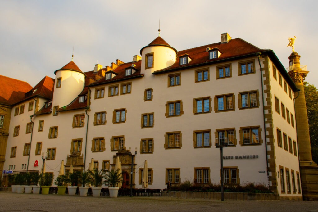 The new castle, known as the neues schloss showing red rooftop, pale yellow building with lots of windows , this is considered Stuttgart's top tourist attraction