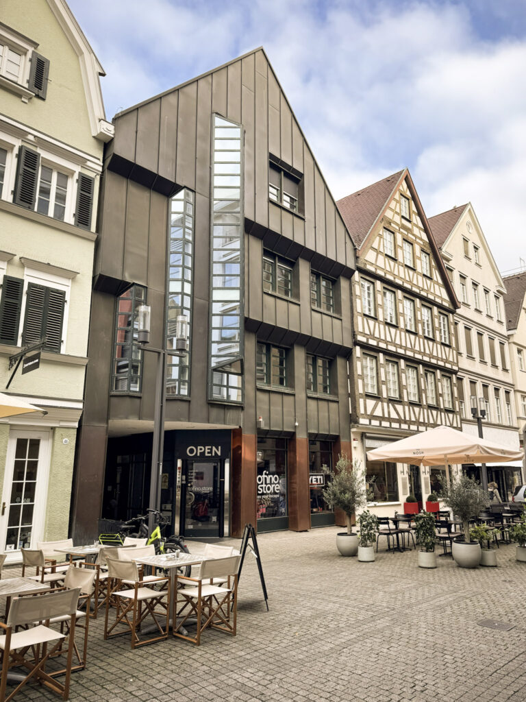 street in stuttgart showing storefronts and dining with table and chairs on street