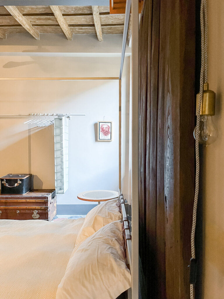 hotel room showing bed and artwork while staying in Rome
