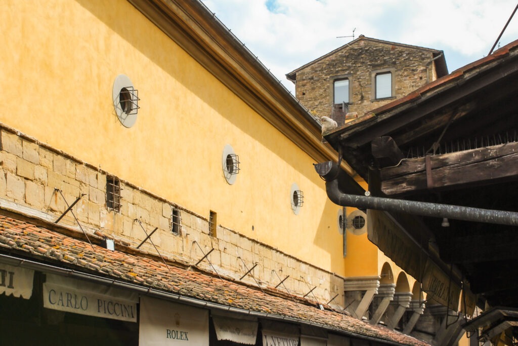 long yellow archway on bridge in florence 