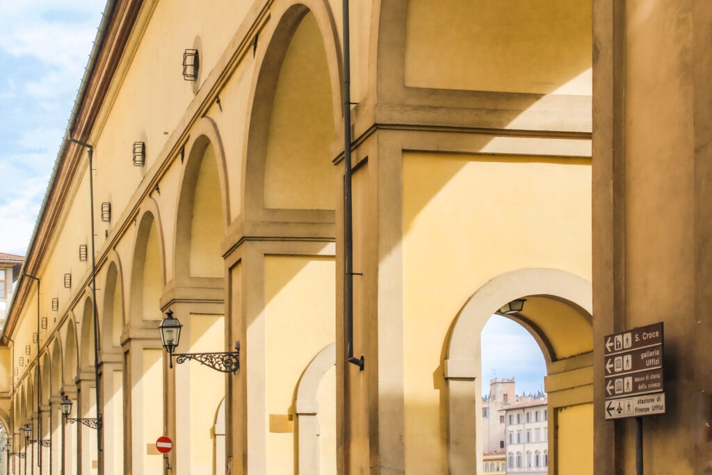 long arcade in florence with blue sky
