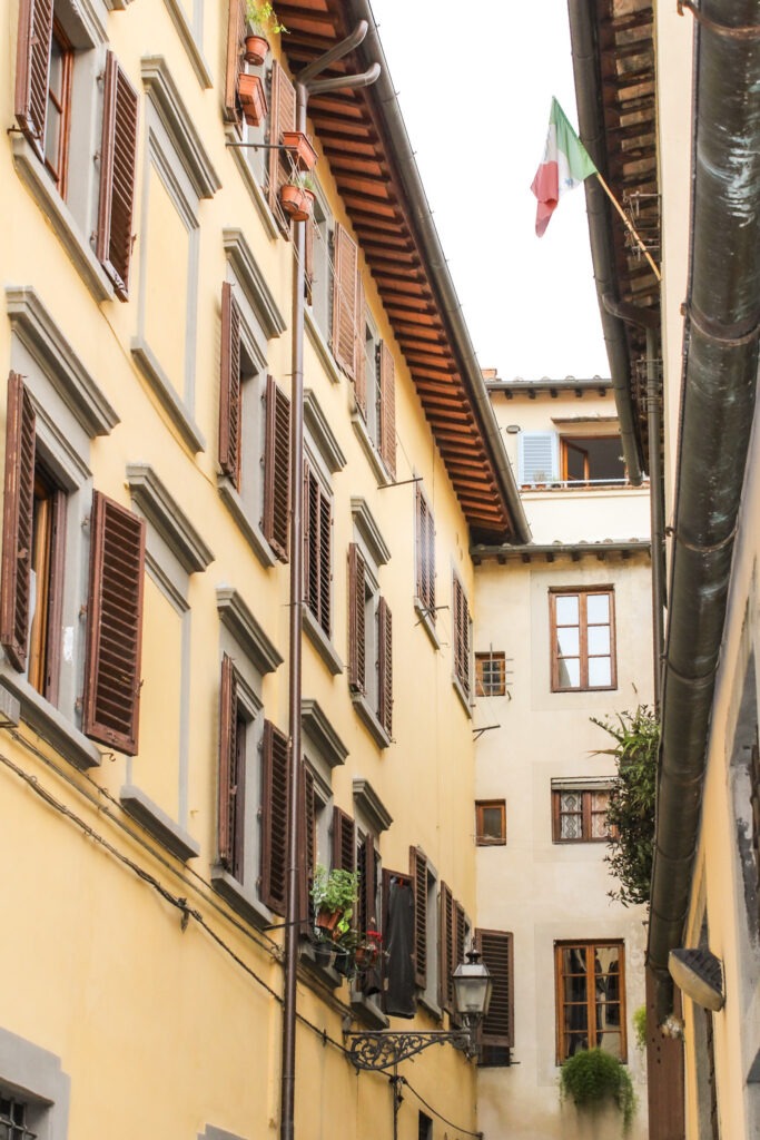 looking up through the buildings with shutters while in florence