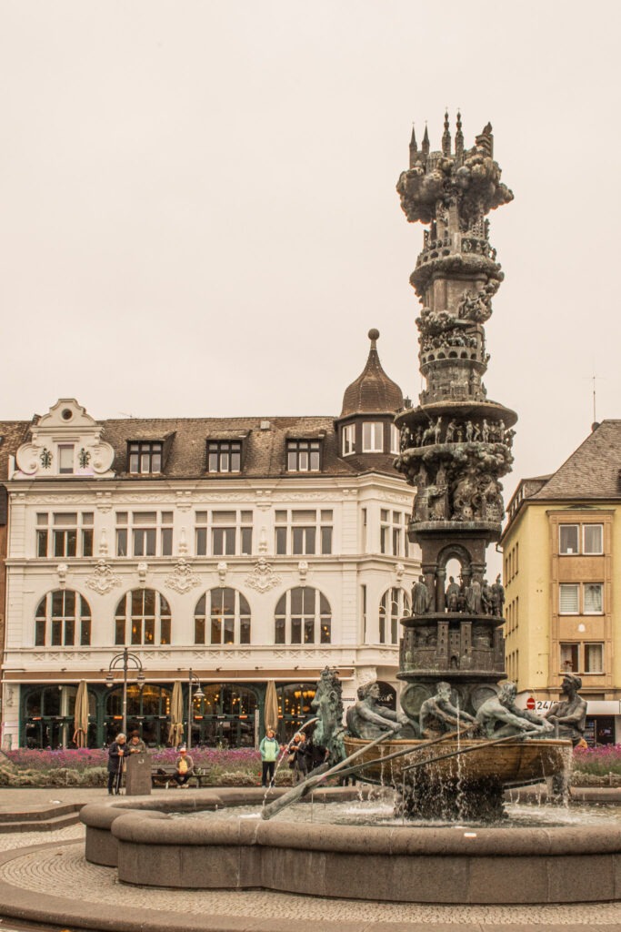 view of cobblestreet and white building with fountain on square while on a visit to koblenz germany