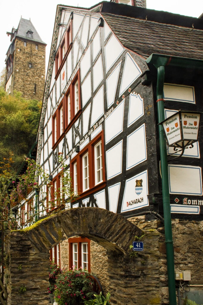 stone gate with timber frame building in bacharach