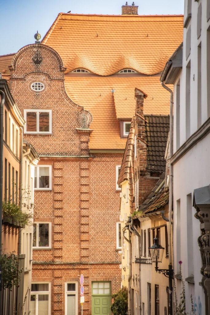 reddish brick with orange sloped roof with windows while in lubeck for the day