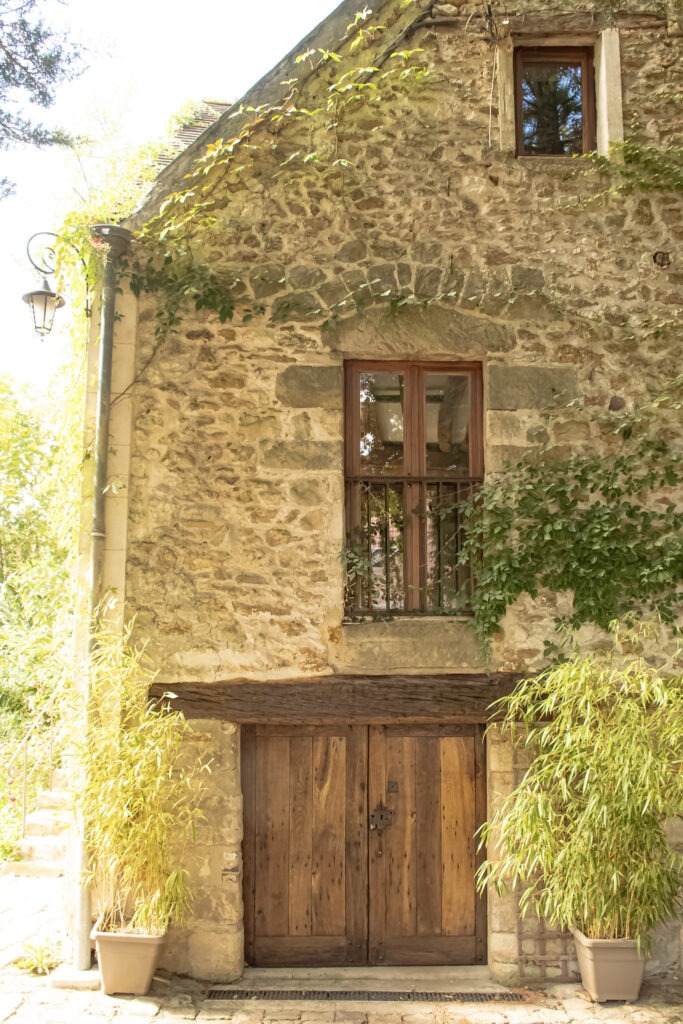 Historic stone exterior of Moulin de Rochopt in the countryside near Paris