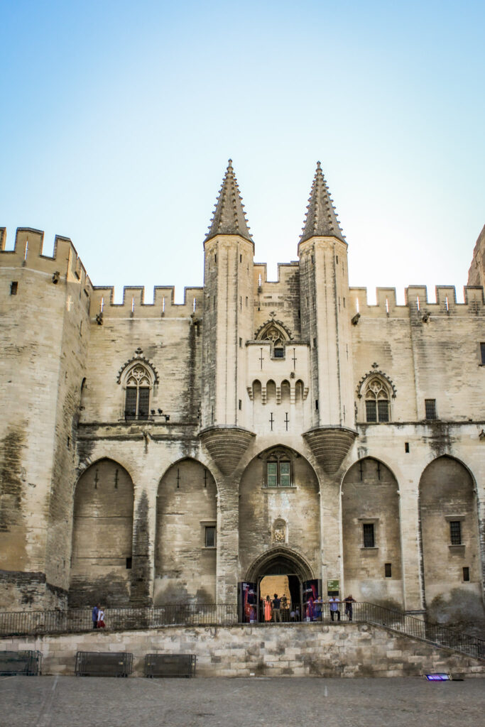 Medieval Gothic façade and entrance of the Palais des Papes in Avignon, France.