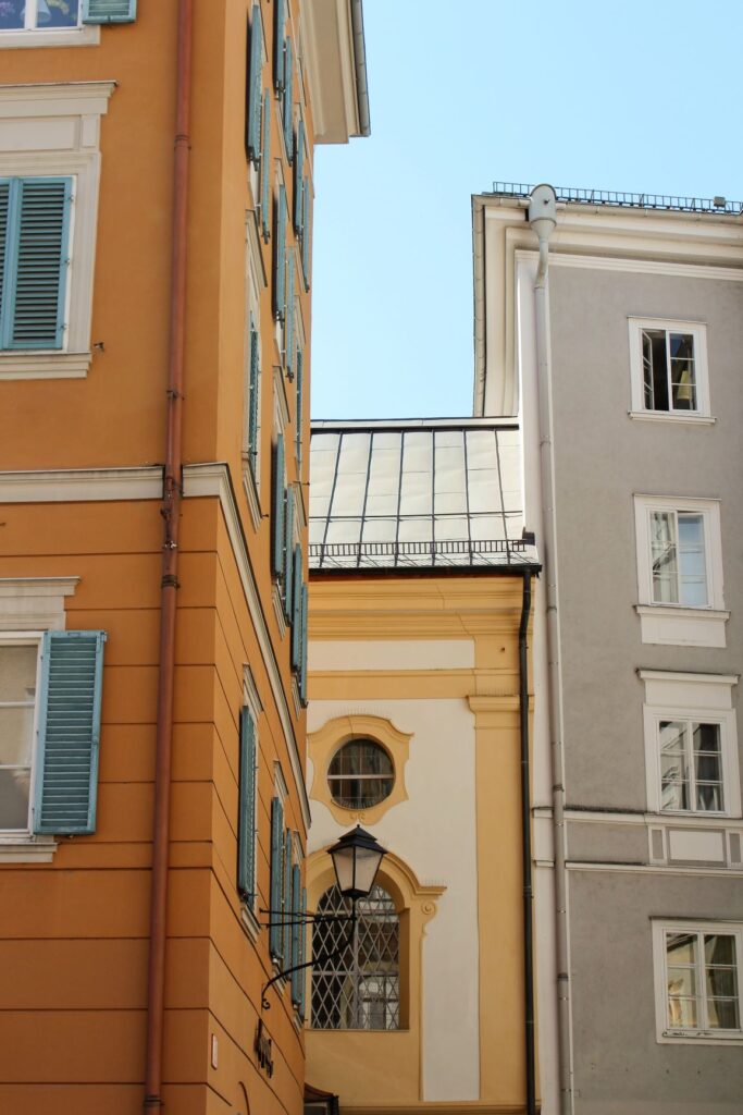 orange, yellow and gray coloured building while spending 1 day itinerary in salzburg