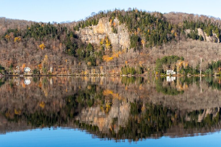 Lake view of Lac-Superieiur at Cabin Spahaus, near Mont Tremblant Quebec, is a 2-bedroom Airbnb vacation rental featuring a spa experience of hot tub, sauna and open shower. This cottage rental includes access to an all-season luxury resort offering full amenities.