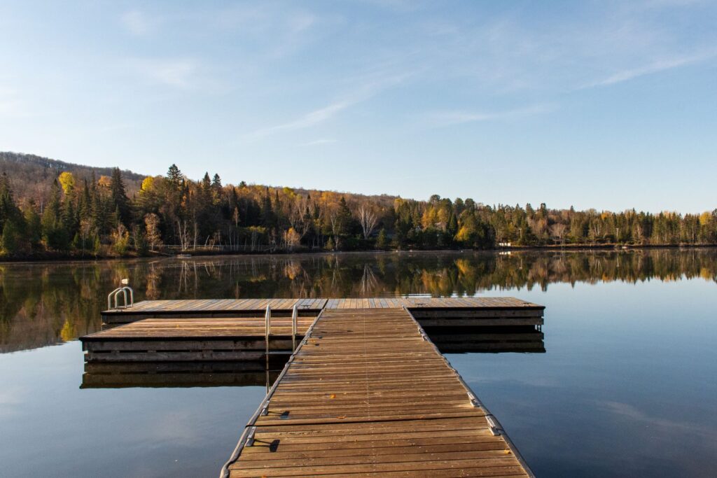 Lake view of Lac-Superieur close to Cabin Spahaus, near Mont Tremblant Quebec, is a 2-bedroom Airbnb vacation rental featuring a spa experience of hot tub, sauna and open shower. This cottage rental includes access to an all-season luxury resort offering full amenities.