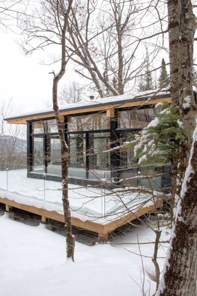 Escape to hintercabin x, a modern prefab Scandinavian-style cabin surrounded by nature. This Airbnb sits atop a hill in the quiet community of La Conception of the Laurentians in Quebec, Canada.