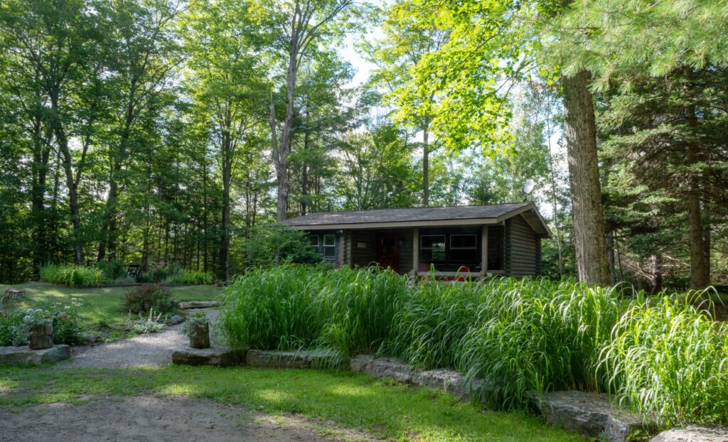 Cranberry Cabins is a cottage rental through Airbnb. This cozy traditional log cabin nestled on a wooden lot in Dysart et al is close proximity to local attractions in Haliburton Highlands in Ontario.