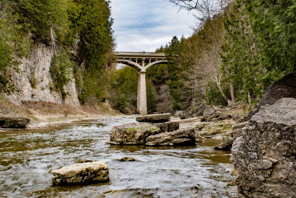 tall bridge over water and rocks in elora