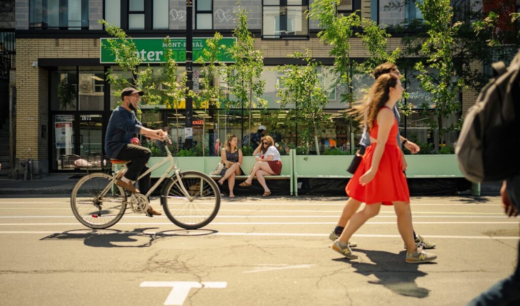 couple walking, cycle on street in best montreal neighborhoods