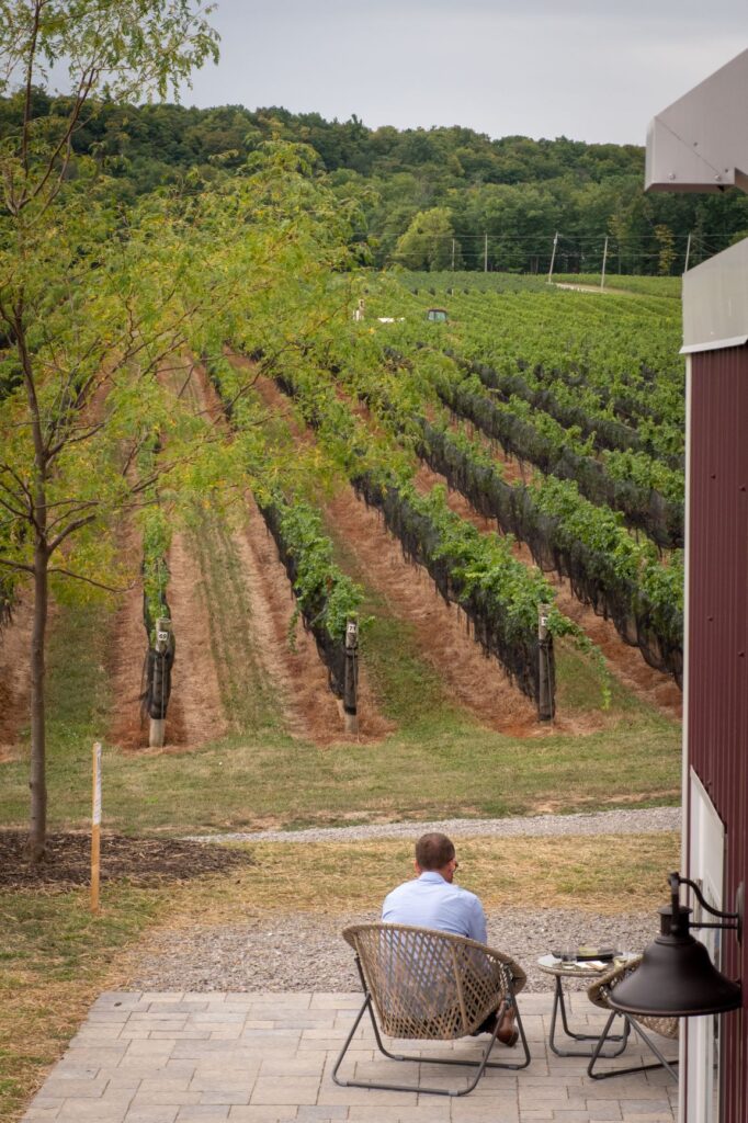 Man sitting in front of winery in Niagara Region wineries in beamsville