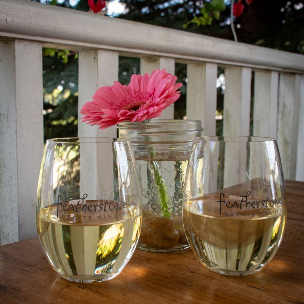 2 glasses of white wine at Feathersone Winery in Niagara beamsville wineries