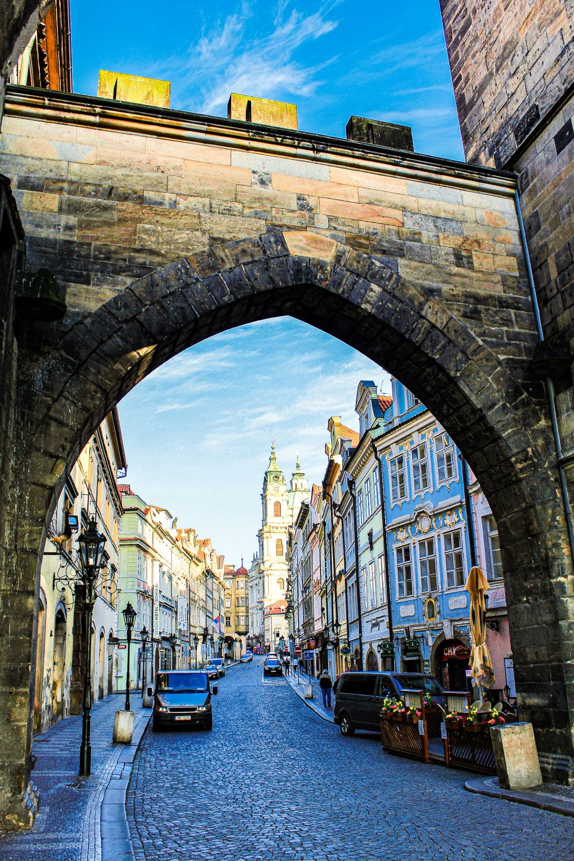 stone archway with cobblestone road