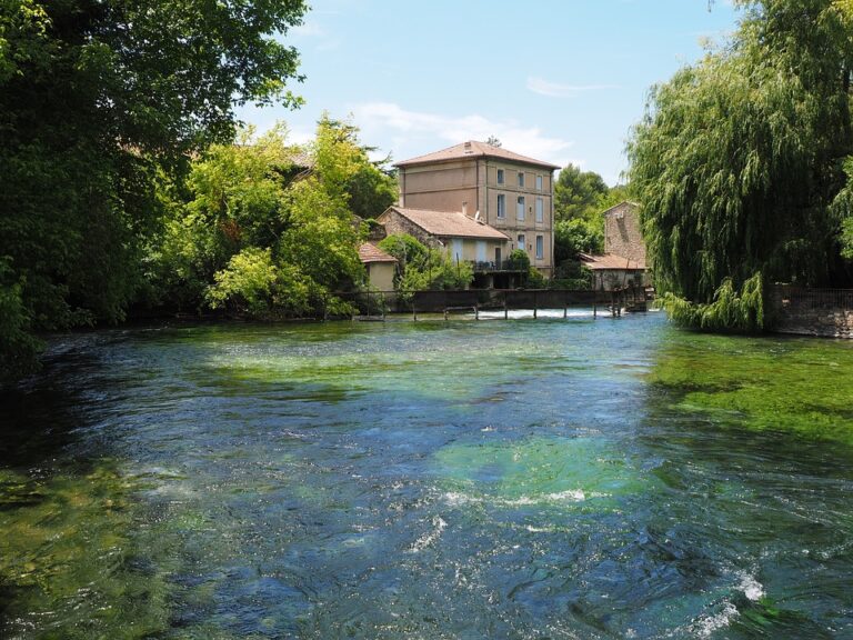 blue water with stone building in Luberon Provence