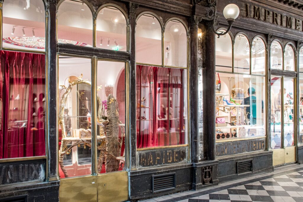 store with red velvet drapes in secret covered passages in paris