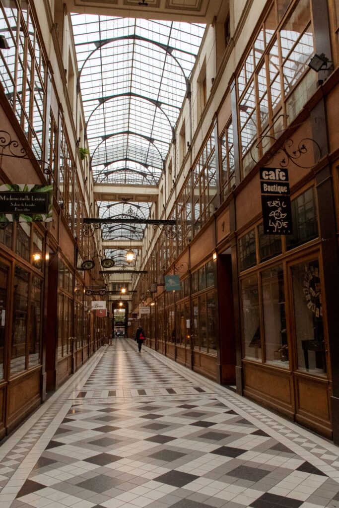 tall passage with iron glass ceiling with checkered floor in covered passages paris