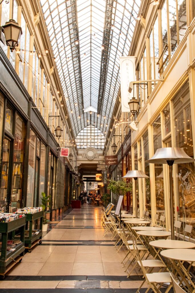 glass domed roof with table and chairs in a covered passage paris