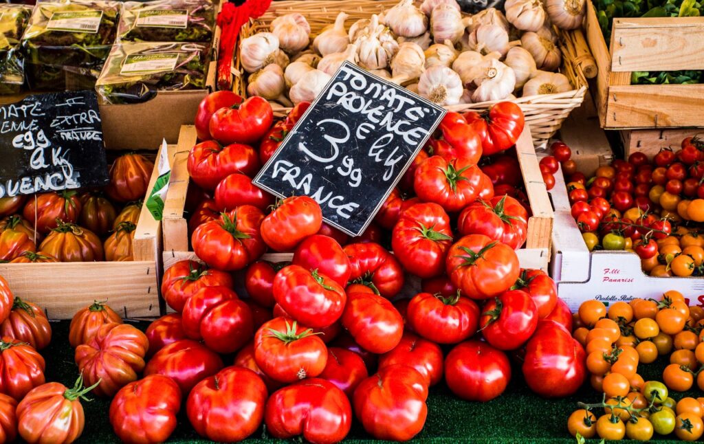 red tomatoes in market stall at farmers market aix en provence
