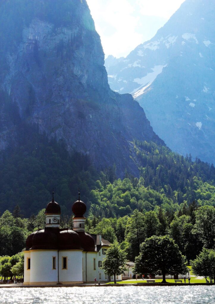 on the lake view of mountains and church by water's edge in Berchtesgaden National Park in Germany