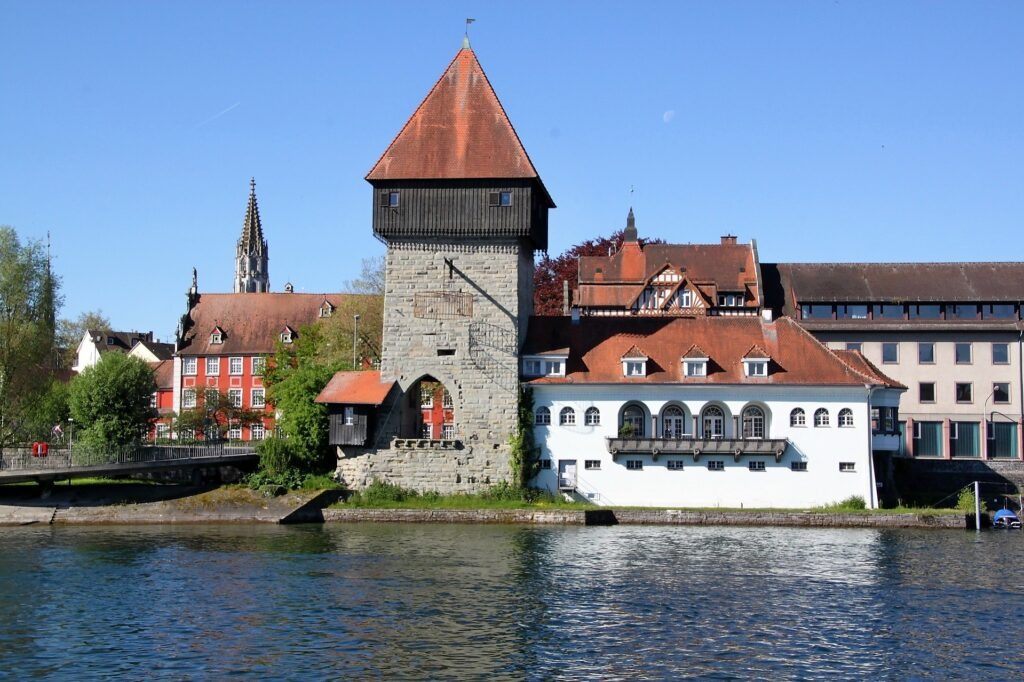 lake with ancient tower with red roof in lake constance germany