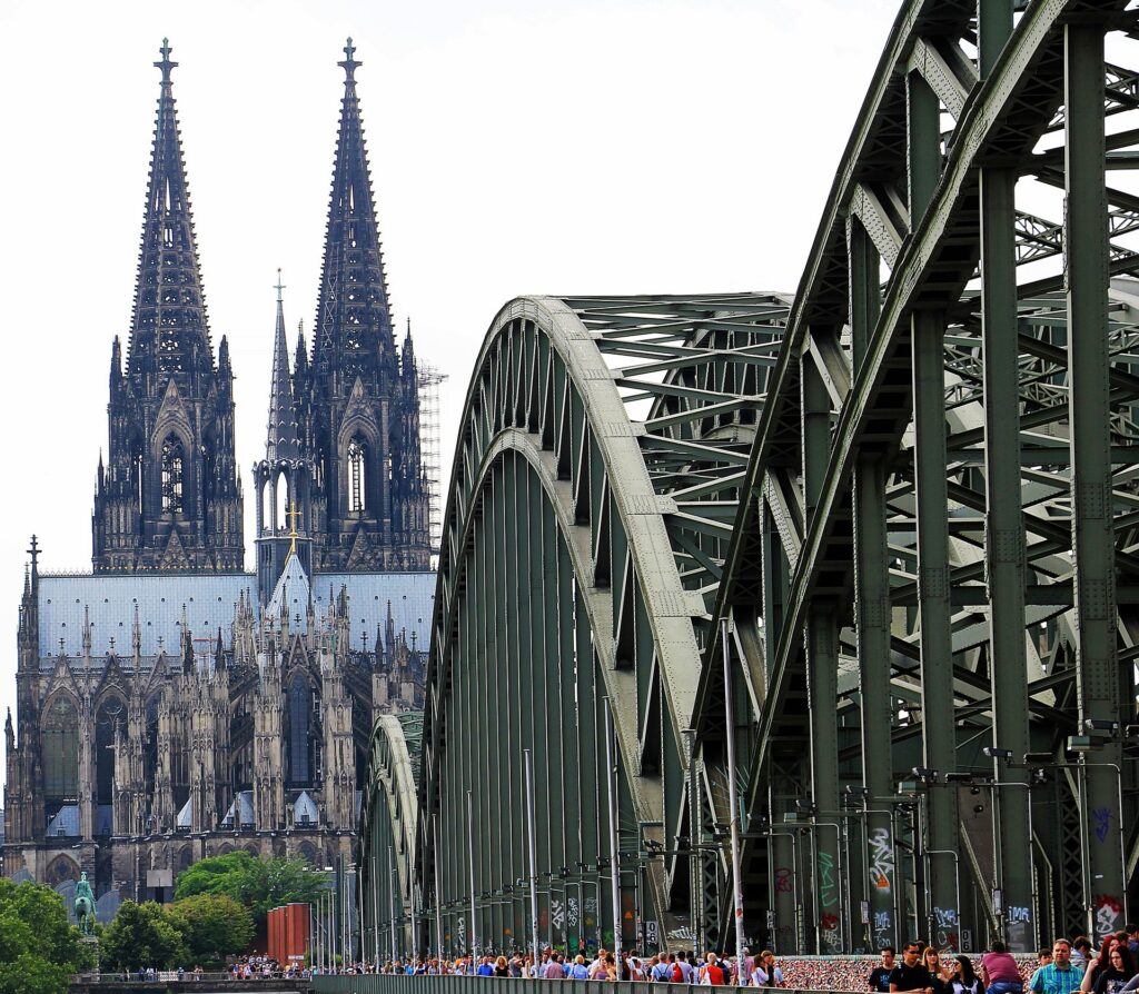 bridge leading to cathedral with 2 towers designated UNESCO sites in germany