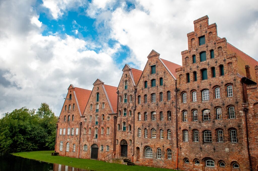 red brick building of 5 tall houses with grass as germany unesco sites