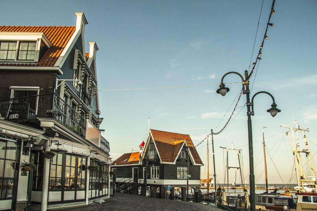green buildings on pier in dutch countryside near amsterdam