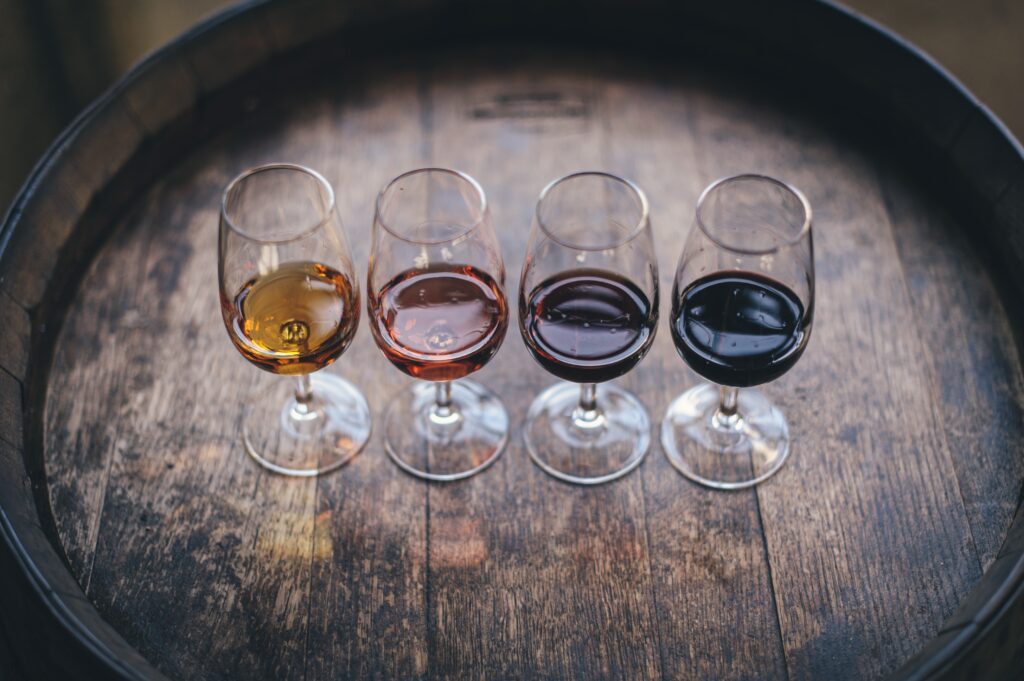 four glasses of port wine on barrel in porto 