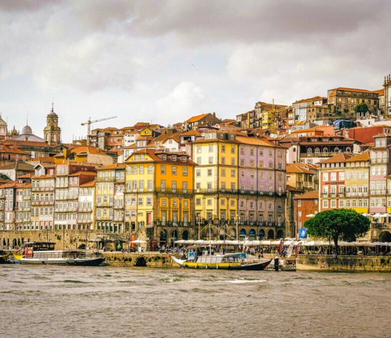 view of Douro river, boats and colourful houses of the riberia district in porto