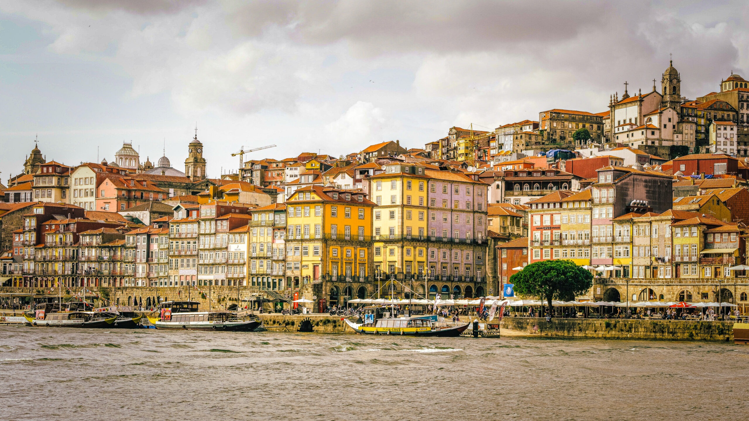 view of Douro river, boats and colourful houses of the riberia district in porto