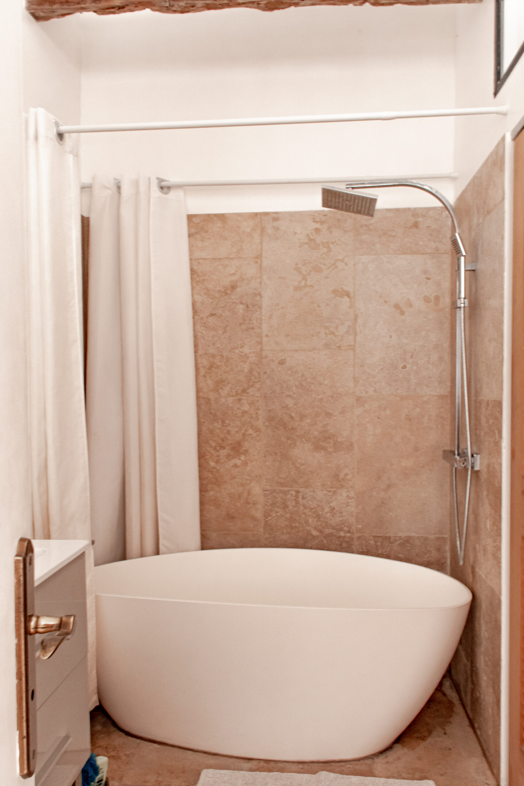 bathtub with rain shower head in paris apartment rental