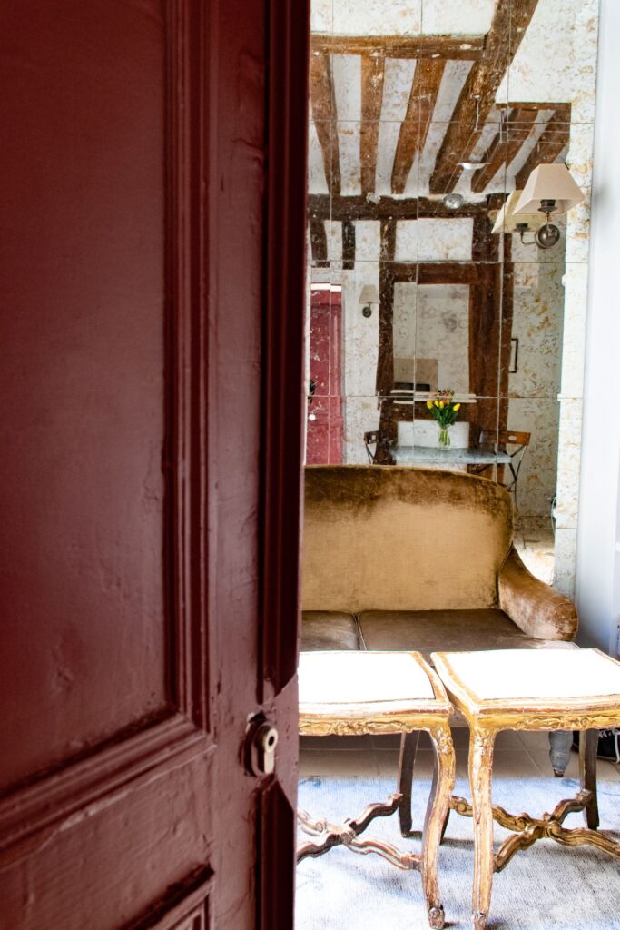 red door with view to sofa with paris vacation apartments