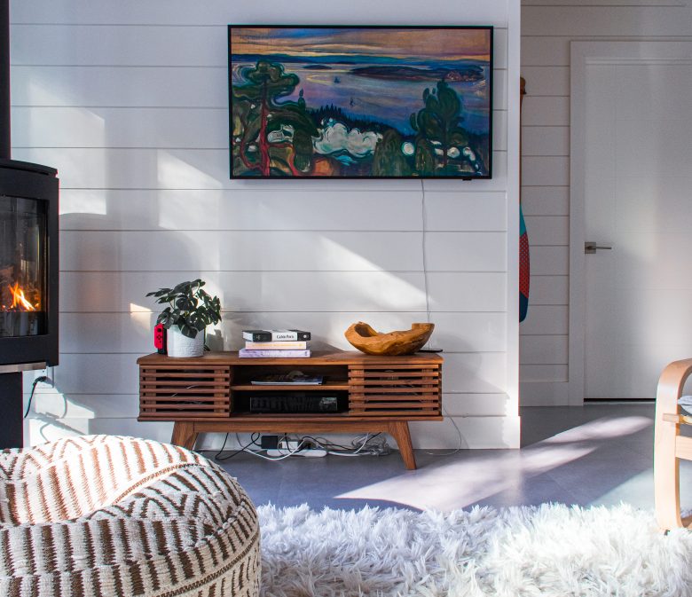 fireplace, chair, rug, artwork in Scandinavian Muskoka cottage