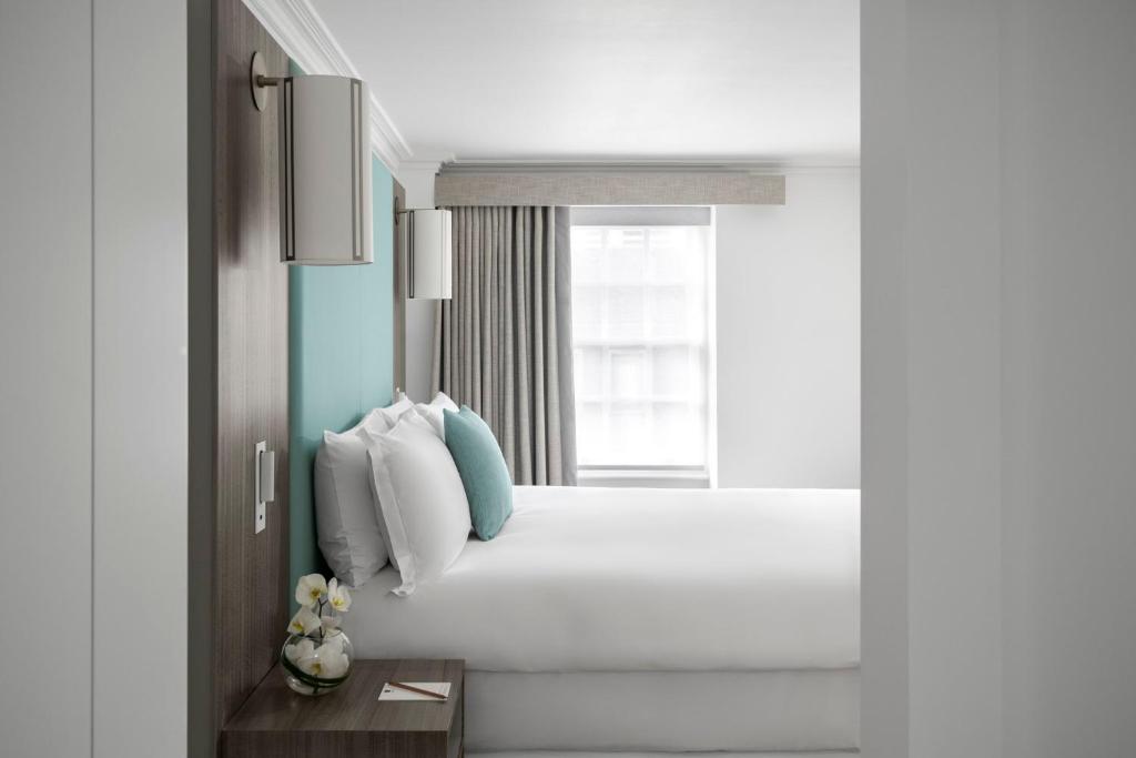 light hotel room with white bedding